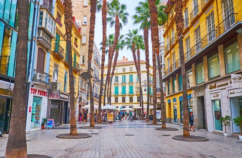 MALAGA, SPAIN - SEPTEMBER 28, 2019: Calle Puerta del Mar street with tall palms, Classic edifices and lots of stores, on Sept 28 in Malaga. MALAGA, SPAIN - SEPTEMBER 28, 2019: Calle Puerta del Mar street with tall palms, Classic edifices and lots of stores, on Sept 28 in Malaga