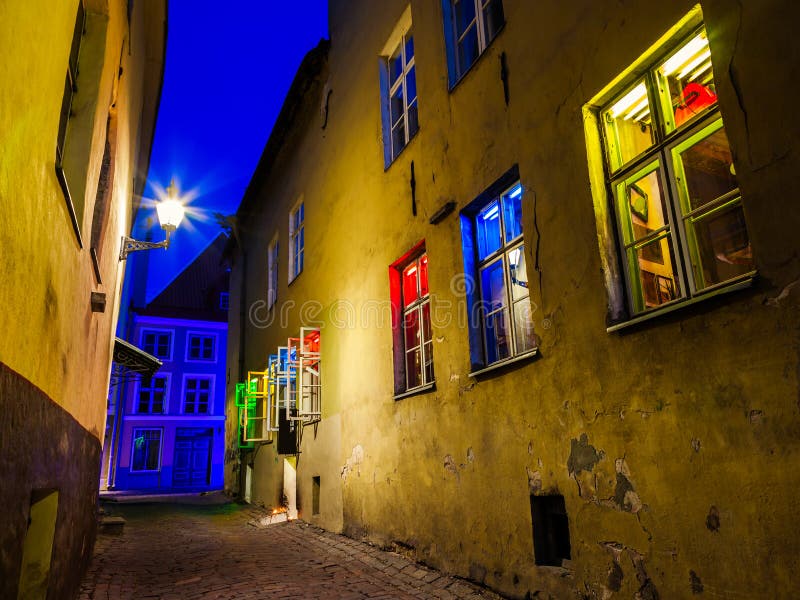 Medieval street and house with illuminated in different colors window in the Historical Centre of Tallinn city at dusk. Tallinn, Estonia. Medieval street and house with illuminated in different colors window in the Historical Centre of Tallinn city at dusk. Tallinn, Estonia.