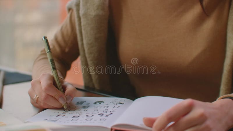 Calligrapher hands writes phrase on white paper. Inscribing ornamental decorated letters. Calligraphy, graphic design stock video