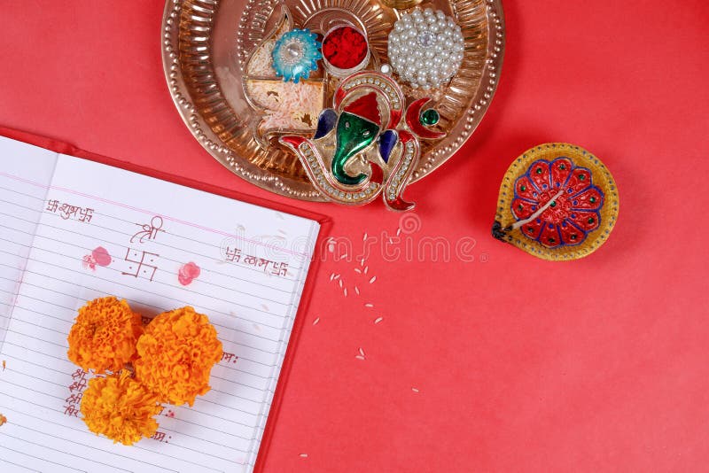Calligraphy writing in hindi Shubha Labh means Goodness & Wealth, over Red accounting note book , diya, stock photos Calligraphy writing in hindi Shubha Labh means Goodness & Wealth, over Red accounting note book , diya, stock photos