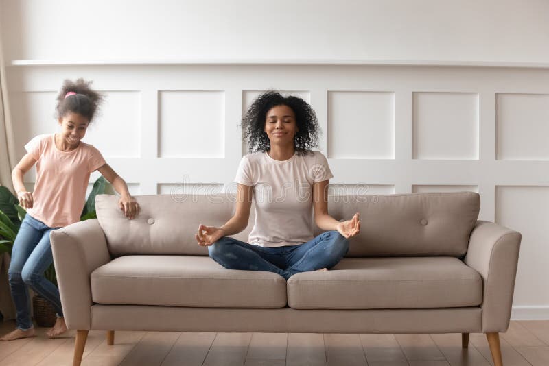 Calm black mom meditate distracted from outer noise