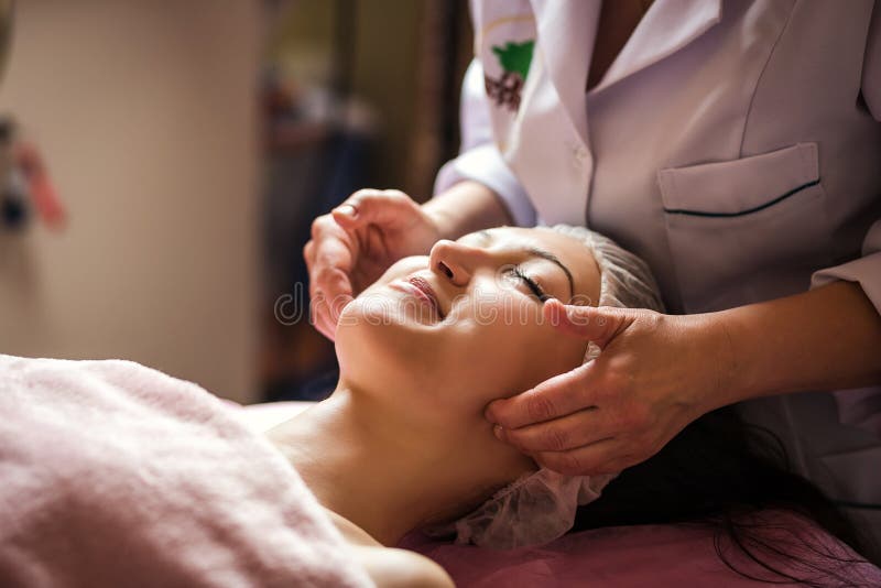 Calm Girl Having Spa Facial Massage In Luxurious Beauty Salon Stock