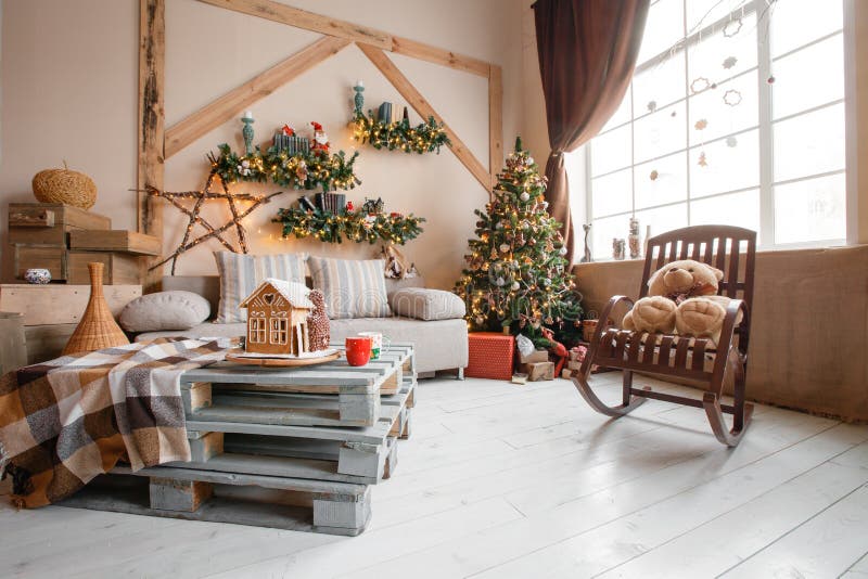 Calm image of interior modern home living room decorated christmas tree and gifts, sofa, table covered with blanket.