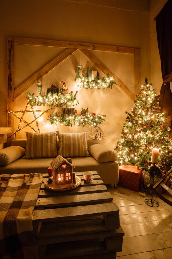 Calm image of interior modern home living room decorated christmas tree and gifts, sofa, table covered with blanket.