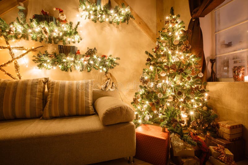 Calm image of interior modern home living room decorated christmas tree and gifts, sofa, table covered with blanket.