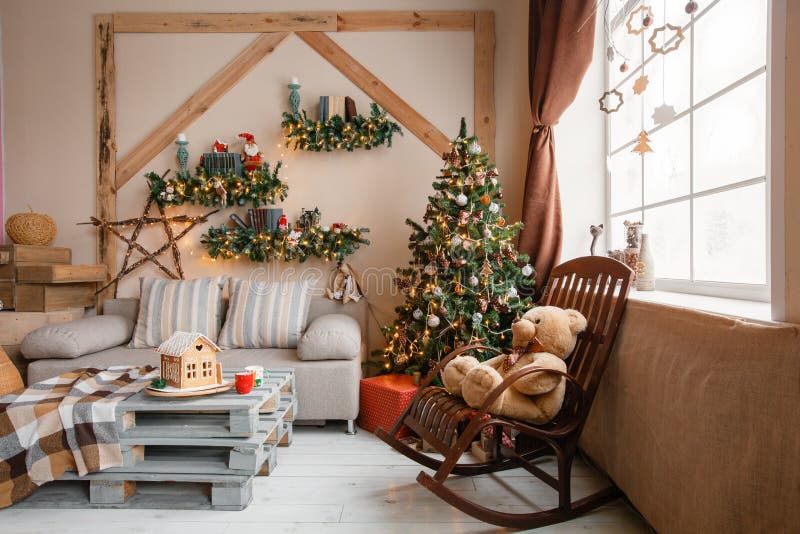 Calm image of interior modern home living room decorated christmas tree and gifts, sofa, table covered with blanket.