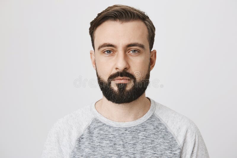 Calm Interesting Bearded Guy in Trendy Shirt with Normal Face Expression,  Looking at Camera while Standing Against Gray Stock Photo - Image of  business, hands: 109125136