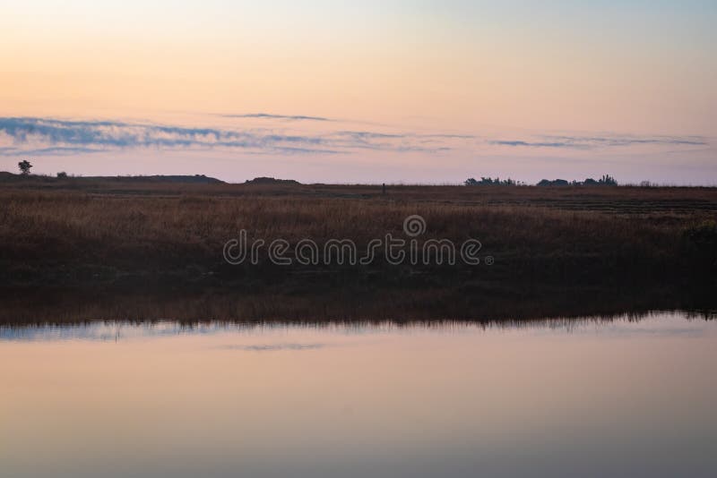 calm lake with dramatic sunrise colorful sky reflection at morning in details.