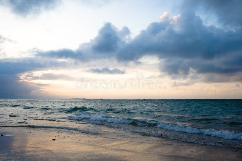 Calm ocean and beach on tropical sunrise