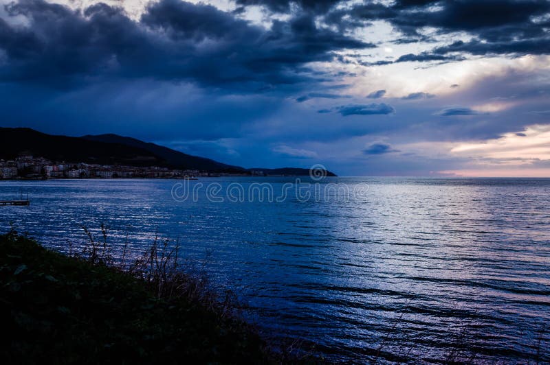 Calm Ocean Before The Storm With Rain Clouds