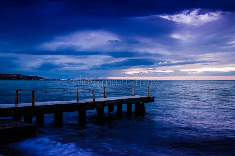 Calm Ocean Before The Storm With Rain Clouds