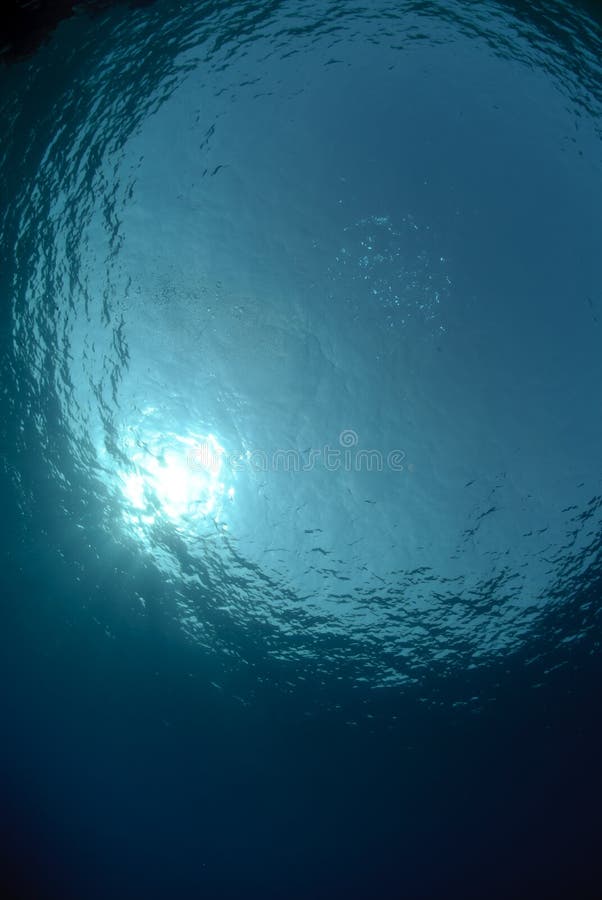 Calm ocean surface and sun. stock image