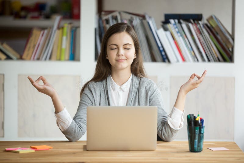 Calm relaxed woman meditating with laptop, no stress at work
