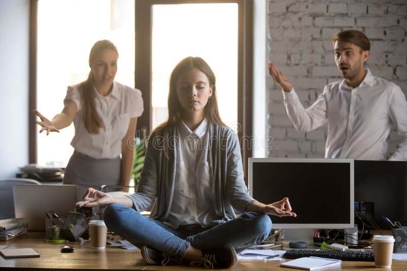 Calm serene employee meditating in office ignoring annoying coll