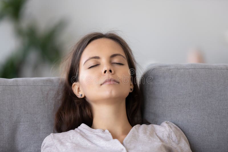 Calm Young Woman Relaxing On Comfortable Sofa With Closed Eyes Close Up Stock Image Image Of 