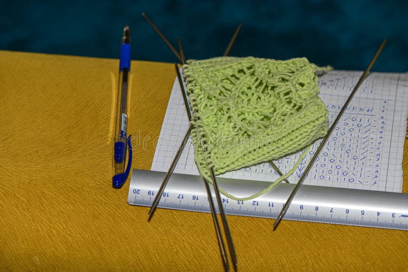 knitting socks knitting needles and drawing lie on the sofa. knitting socks knitting needles and drawing lie on the sofa