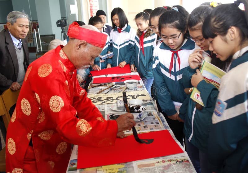 HAI DUONG, VIETNAM, March 18: calligraphers writing art letters for visitors on March, 18, 2014 in Hai Duong, Vietnam. These letters will hang in home for luck. HAI DUONG, VIETNAM, March 18: calligraphers writing art letters for visitors on March, 18, 2014 in Hai Duong, Vietnam. These letters will hang in home for luck.