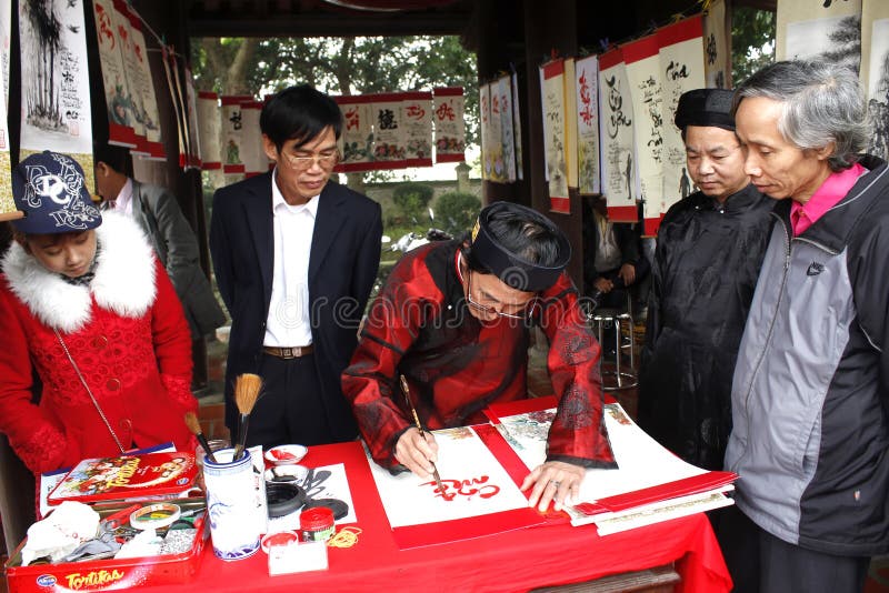 HAI DUONG, VIETNAM, March 18: calligraphers writing art letters for visitors on March, 18, 2014 in Hai Duong, Vietnam. These letters will hang in home for luck. HAI DUONG, VIETNAM, March 18: calligraphers writing art letters for visitors on March, 18, 2014 in Hai Duong, Vietnam. These letters will hang in home for luck.