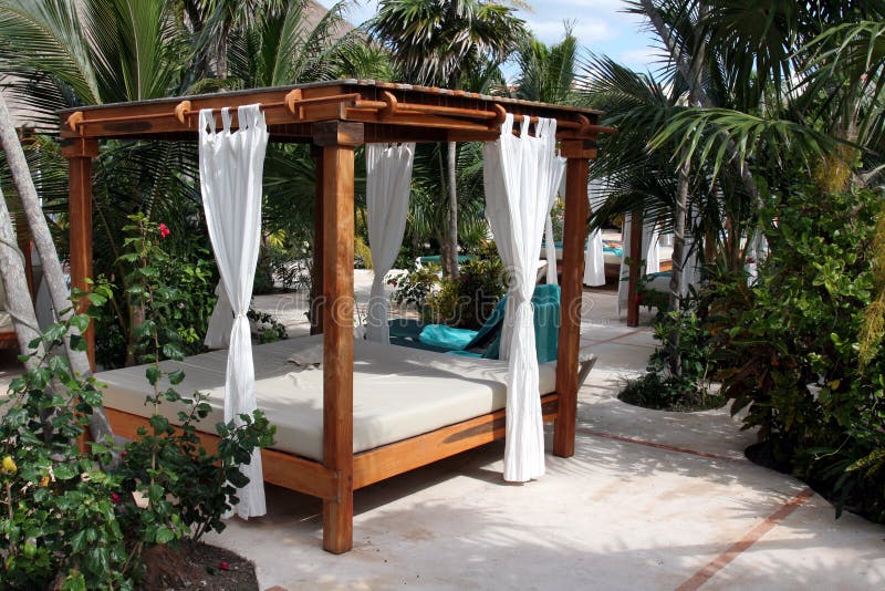 A poolside beach bed at a tropical resort. A poolside beach bed at a tropical resort.