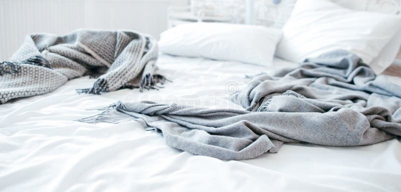 Sleep disorder, insomnia. Empty messy unmade bed. Cozy home textile in bedroom. Warmth and comfort. Sleep disorder, insomnia. Empty messy unmade bed. Cozy home textile in bedroom. Warmth and comfort.