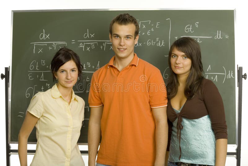 Small group of teenagers standing in front of blackboard. Smiling and looking at camera. Front view. Small group of teenagers standing in front of blackboard. Smiling and looking at camera. Front view