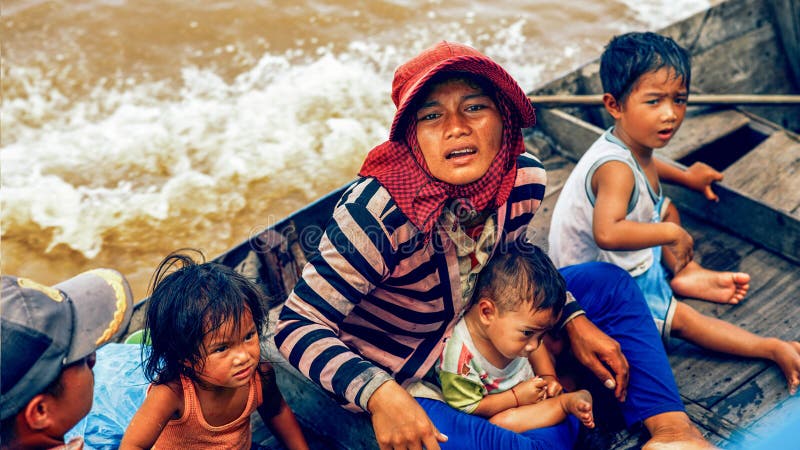 Cambodian people live on Tonle Sap Lake in Siem Reap, Cambodia. Cambodian family on a boat near the fishing village of Tonle Sap L