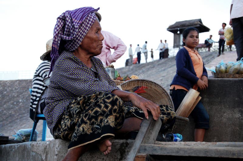Cambodian senior old women people sit for sale product to foreign travelers travel visit West Mebon temple castle on island in royalty free stock photo Cambodian senior old women people sit for sale product to foreign travelers travel visit West Mebon temple castle on island in royalty free stock photo