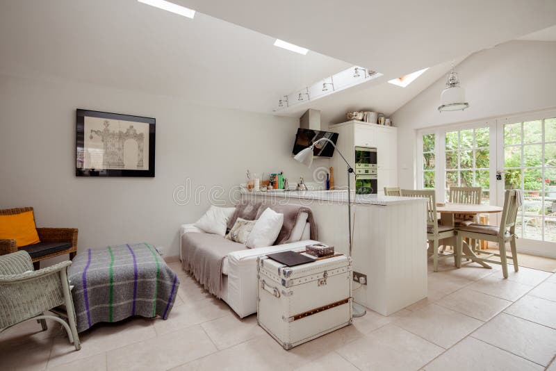 Saffron Walden, Essex, England - Sept 4 2018: Open plan furnished luxury fitted cottage kitchen and family room with sloping vaulted ceiling. Saffron Walden, Essex, England - Sept 4 2018: Open plan furnished luxury fitted cottage kitchen and family room with sloping vaulted ceiling