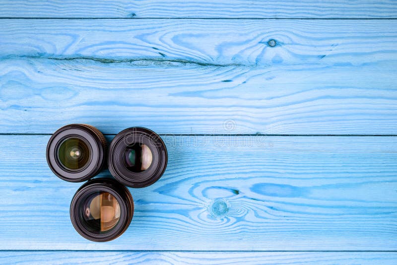 Camera Lenses on Wooden Table Top View. Background and Workspace for