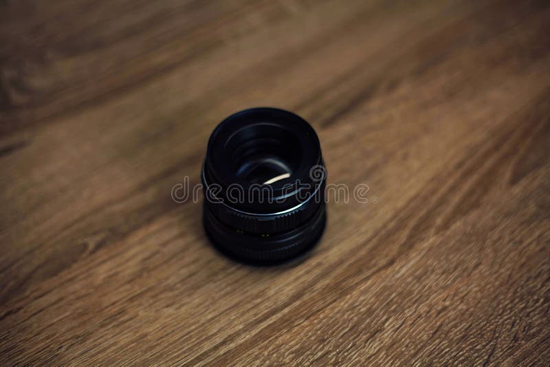 Camera Lenses on a Wooden Table Top View. Background and Workspace for