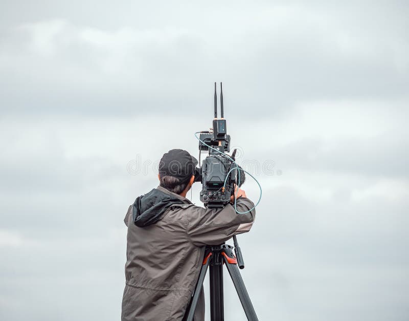 Camera operator filming an event in Bucharest, Romania, using a modern video camera royalty free stock image
