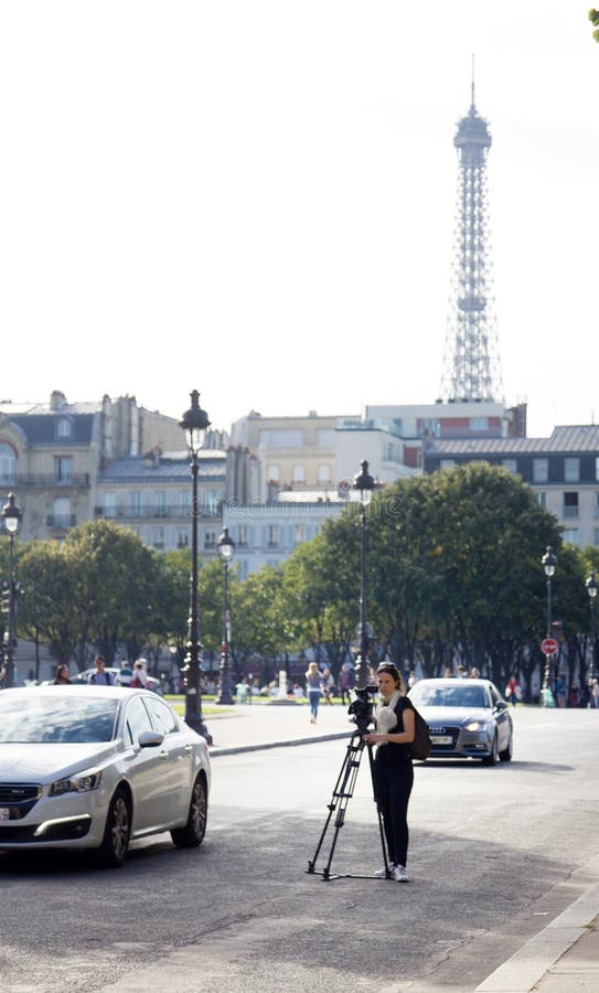 France, Paris - 24 September 2017: girl cameraman shoots a movie camera on the street. France, Paris - 24 September 2017: girl cameraman shoots a movie camera on the street