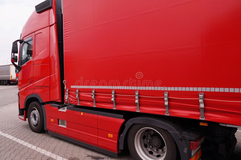 Transport and unloading. Truck with semi-trailer with covered tarpaulin. Transport and unloading. Truck with semi-trailer with covered tarpaulin.