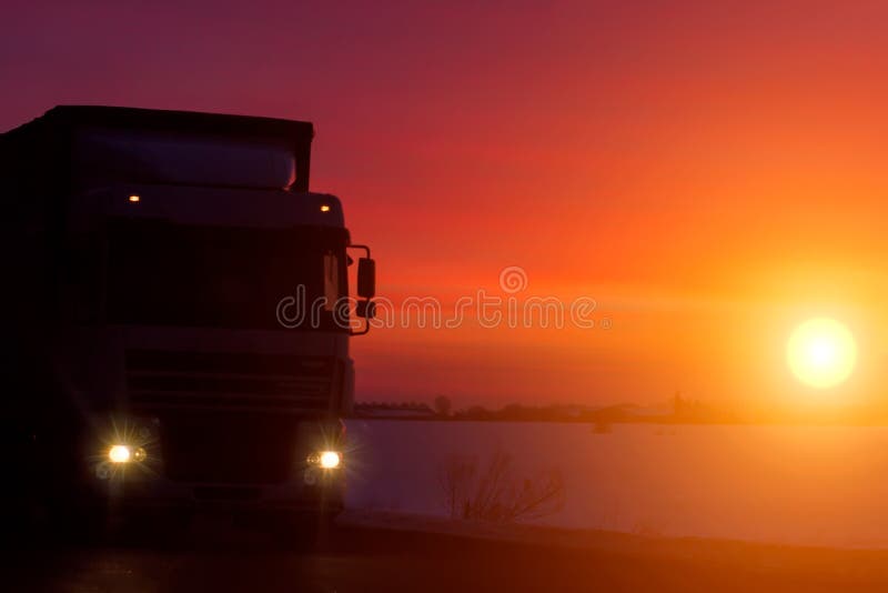 Caminhão da silhueta com o recipiente na estrada, conceito do transporte da carga Fundo do por do sol com espaço da cópia imagens de stock royalty free Caminhão da silhueta com o recipiente na estrada, conceito do transporte da carga Fundo do por do sol com espaço da cópia imagens de stock royalty free