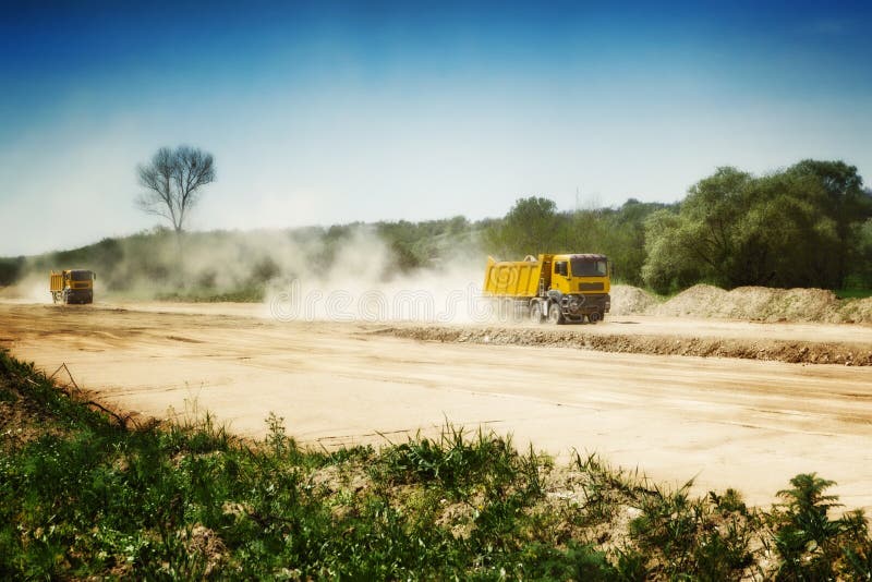 Two heavy truck on dusty road. Two heavy truck on dusty road