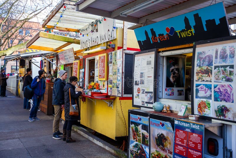 PORTLAND, OR - FEBRUARY 2, 2016: Food trucks and carts in downtown PDX offer lunch and other meails for inexpensive prices near major office buildings. PORTLAND, OR - FEBRUARY 2, 2016: Food trucks and carts in downtown PDX offer lunch and other meails for inexpensive prices near major office buildings.