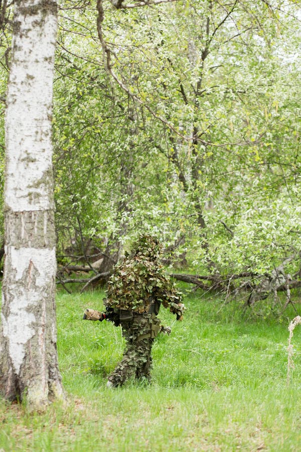 Camouflaged sniper lying in forest and aiming through his scope Stock Photo  by ©Nesterenko_Max 89112398