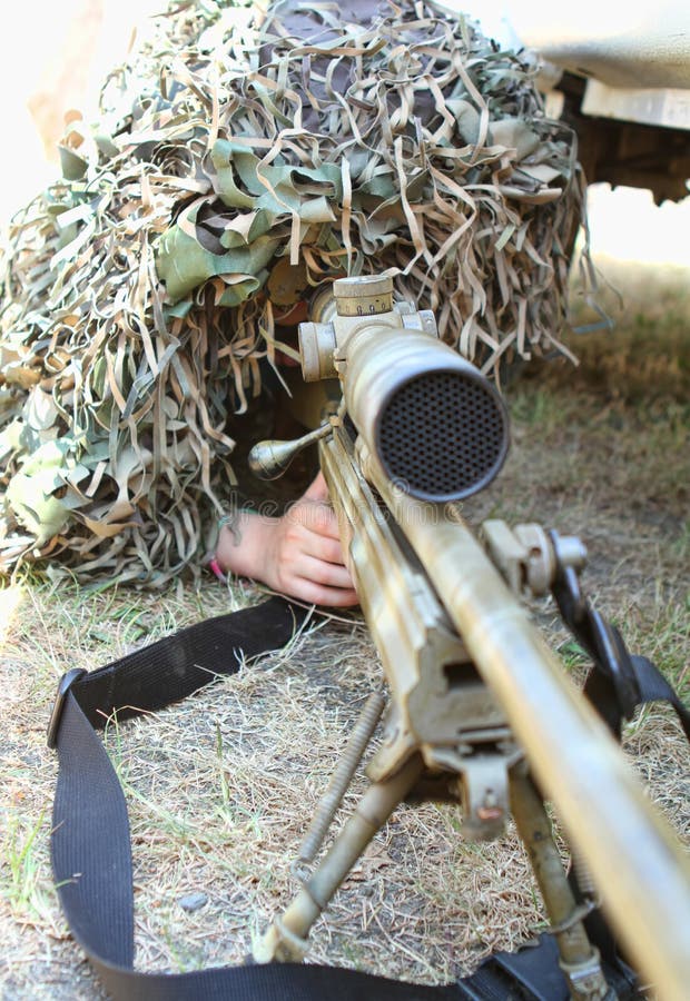 Camouflaged sniper lying in forest and aiming through his scope Stock Photo  by ©Nesterenko_Max 89112398