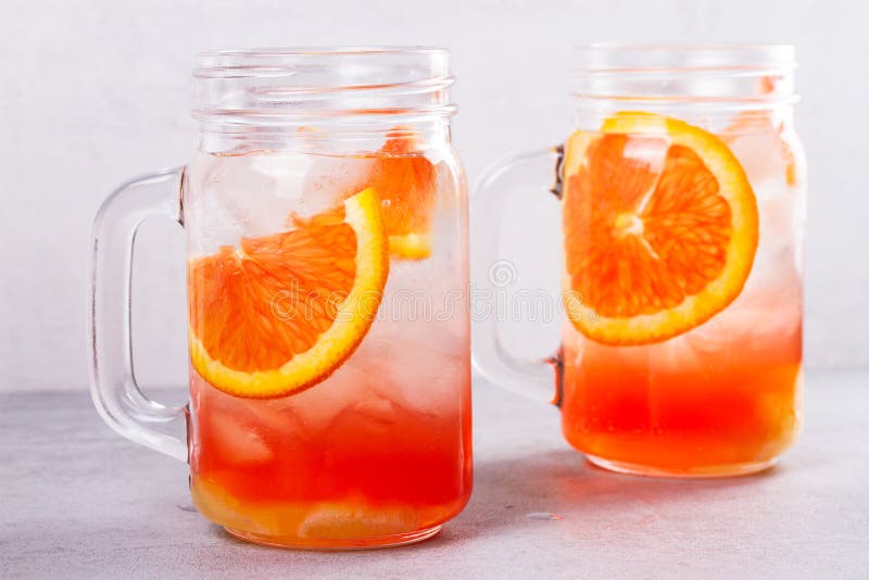 Campari and Vermouth Cocktail with Oranges, Garnished with Thyme. Stock