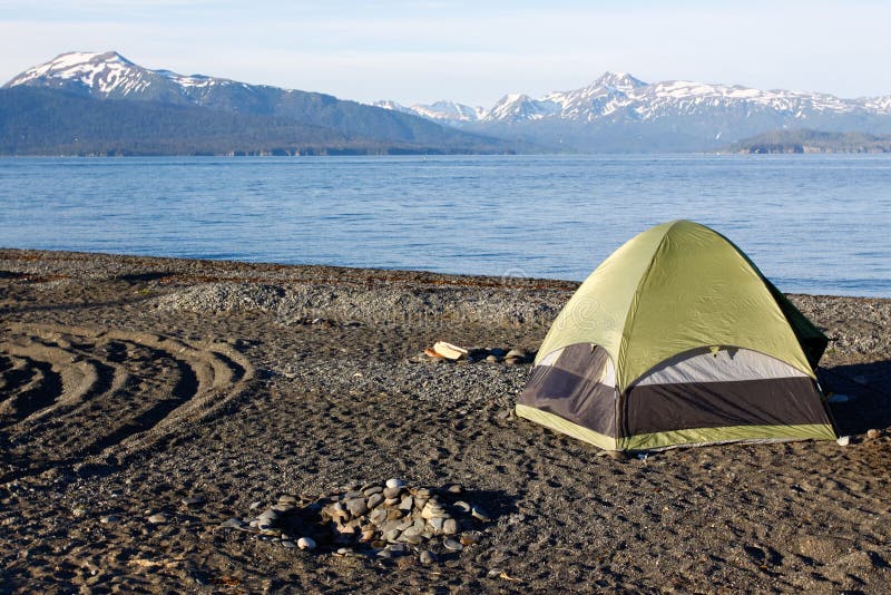 Many visitors to Homer, Alaska choose to camp, either in recreational vehicles, campers, or in this case tent camping right on the beach in a specially designated area on the world famous Homer Spit, located at the end of Kenai Peninsula and surrounded by Kachemak Bay. A common summer cruise ship port of call, located on the very end of the Kenai Peninsula and part of the Pacific Ocean Ring of Fire, Homer is famous for commercial and recreational fishing, particularly halibut, outdoor recreation opportunities, and its eclectic artist vibe is popular with both Alaskans and tourists alike. Many visitors to Homer, Alaska choose to camp, either in recreational vehicles, campers, or in this case tent camping right on the beach in a specially designated area on the world famous Homer Spit, located at the end of Kenai Peninsula and surrounded by Kachemak Bay. A common summer cruise ship port of call, located on the very end of the Kenai Peninsula and part of the Pacific Ocean Ring of Fire, Homer is famous for commercial and recreational fishing, particularly halibut, outdoor recreation opportunities, and its eclectic artist vibe is popular with both Alaskans and tourists alike.