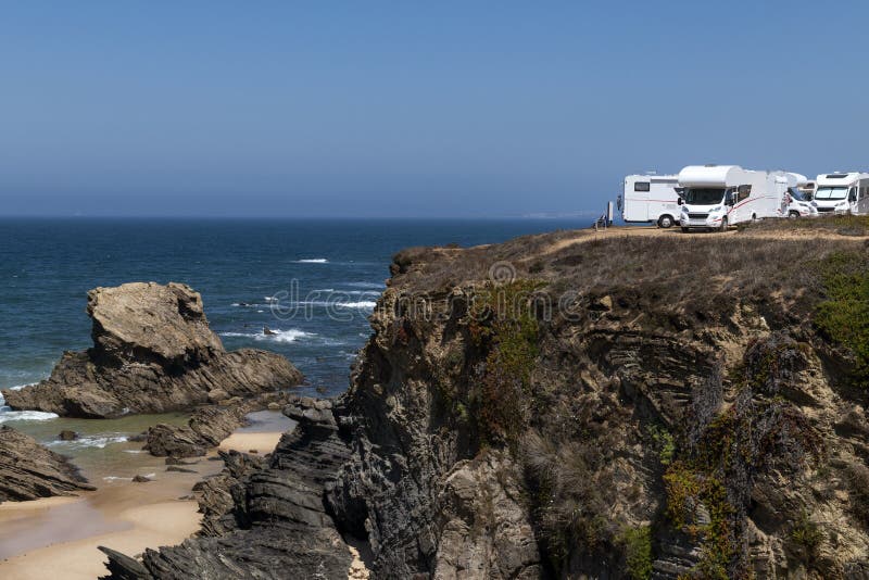 Campers parked on a cliff near the village of Porto Covo, in the Costa Vicentina Natural Park in Portugal