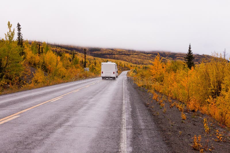 Campervan driving autumn fall highway Yukon Canada