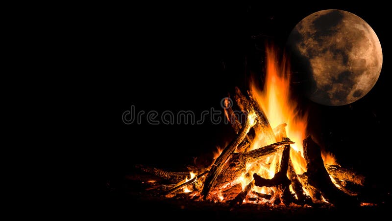 Campfire under a full moon. Fire burning under a full moon on a dark night with space to write at left side