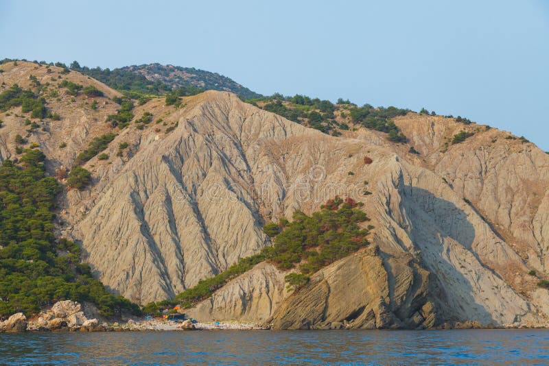 Camping on the beach in the rocks. View from the water to the bareg. Gray water snake stock images, royalty-free photos and pictures
