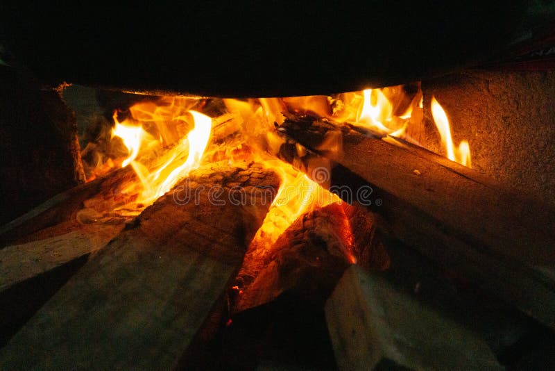 Firewood Burns Inside the Fireplace with Fire and Smoke Stock Image