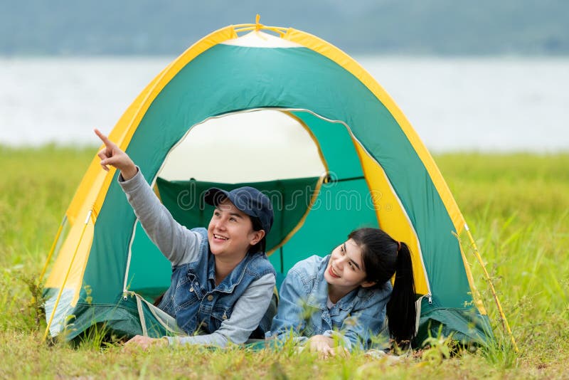 Camping outdoor. Group friends camping leisure and destination travel. Family sitting around camp fire and playing guitar and roa royalty free stock photo Camping outdoor. Group friends camping leisure and destination travel. Family sitting around camp fire and playing guitar and roa royalty free stock photo