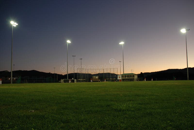 Image was taken of a baseball field of an evening. Image was taken of a baseball field of an evening