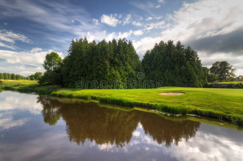 Idyllic golf course with reflection in the river. Idyllic golf course with reflection in the river