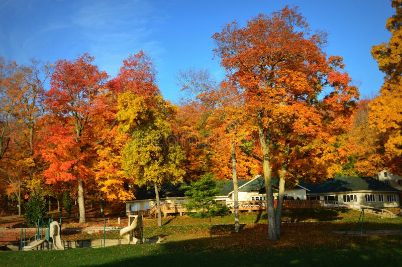 Covenant Harbor Bible Camp located in Lake Geneva, Wisconsin which is in Walworth County. The morning sun is shining onto the park and dining hall and showing off the brilliant fall colors on the trees that surround the building. Covenant Harbor Bible Camp located in Lake Geneva, Wisconsin which is in Walworth County. The morning sun is shining onto the park and dining hall and showing off the brilliant fall colors on the trees that surround the building.