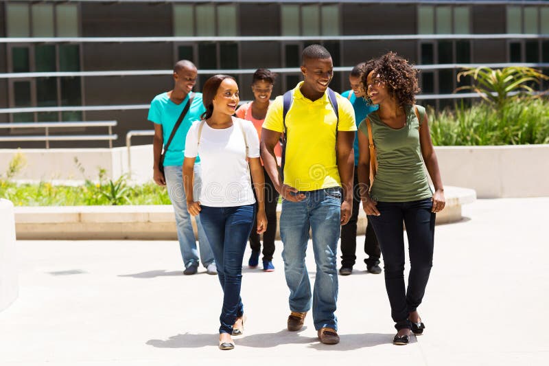 Group of happy african american college students walking on modern campus. Group of happy african american college students walking on modern campus